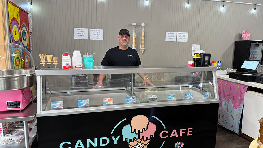 Leo V. Kaplan/City Pulse
Candy Café co-owner Todd Jenkins greets customers behind the shop’s ice cream cooler, which features 16 flavors from Hershey Creamery Co.