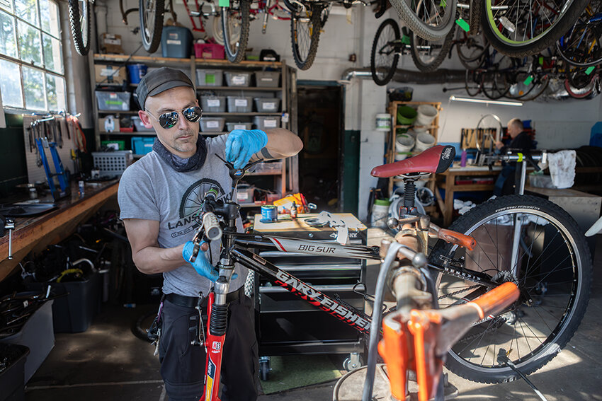 Raymond Holt for City Pulse
Co-op President Trevor Benoit repairs a recently donated bicycle.
