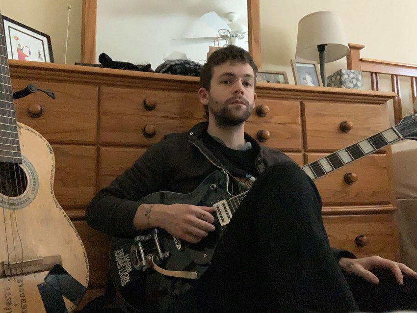 John Warmb with his guitars in his bedroom, his defacto venue and studio.