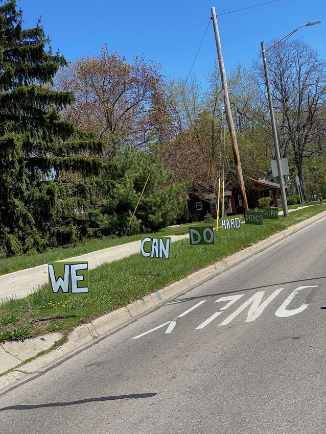 &quot;We can do hard things together,&quot; say signs along Grand River Avenue near Hagadorn Road in East Lansing.