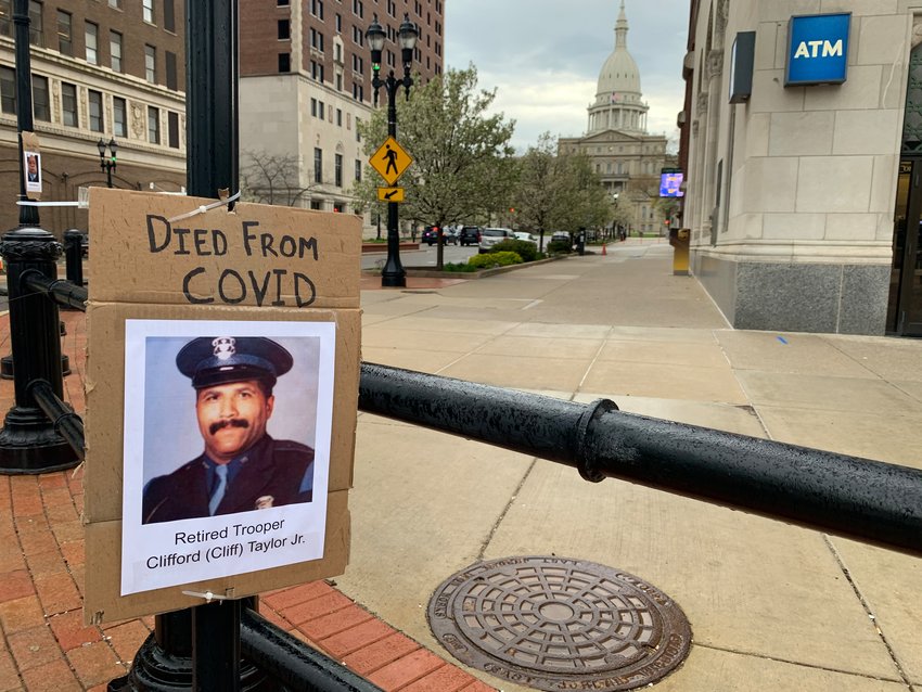 Signs posted across downtown Lansing last week paid tribute to victims of COVID-19.