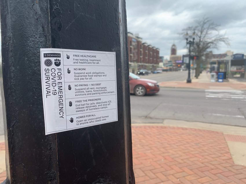 Unsigned demands on a post at the intersection of Michigan Avenue and Larch Street in downtown Lansing.