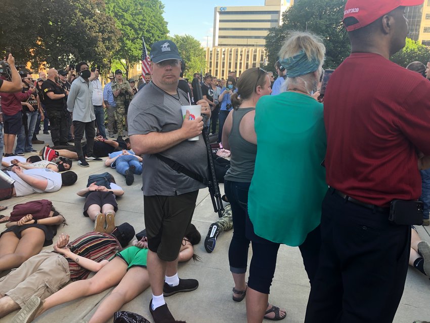 Hundreds of protesters attending the American Patriot Rally at the Capitol tonight had company: About 40 civil rights protesters lay prone among them in memory of George Floyd.