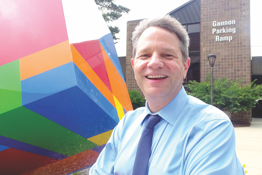 Steve Robinson, who will become Lansing Community College&rsquo;s president Monday, next to &ldquo;Newton&rsquo;s Cube,&rdquo; designed by Bruce Mackley, one of many sculptures his predecessor, Brent Knight, added to the campus. &ldquo;The campus is absolutely transformed since when I was an intern in the Arts and Science Building in the early &lsquo;90s,&rdquo; Robinson said.