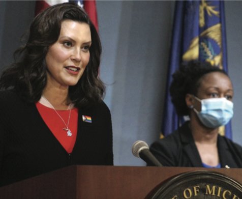 Gov. Gretchen Whitmer at a press conference in June announcing executive orders to open business.