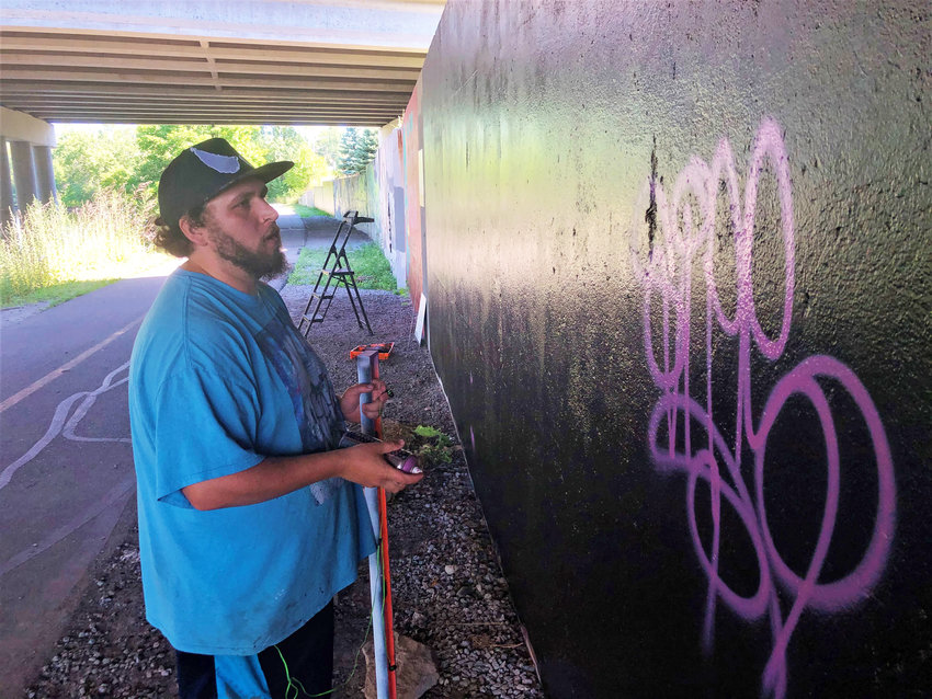 Isiah Lattimore began work on restoring the George Floyd mural this morning.