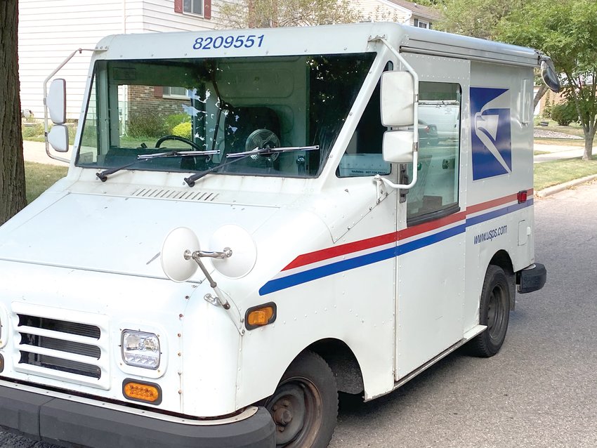 A mail truck parked in Lansing, where a postal union official said she sees little problem making timely deliveries in central Michigan. But mail ballots early, she advises.