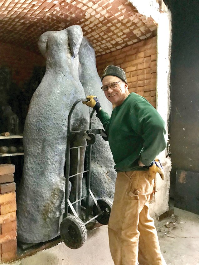 Mark Chatterly from Chatterly Sculptures Inc. posing with one of his finished creations.