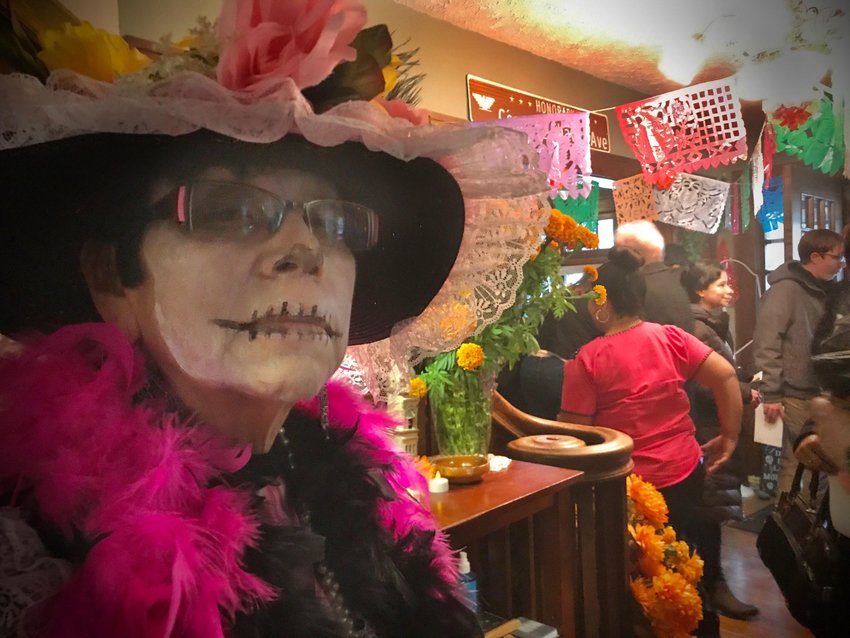 Rosa Lopez Killips dressed as a Catrina. The Mexican tradition of wearing large hats, fancy clothes and sugar skull face serve as a reminder that we do not carry our wealth with us when passing. One of the ofrendas nominated by the Dia de Los Muertos Advisory Committee honors the life of Rosa who passed away this year. Rosa organized decades of Dia de Los Muertos celebrations in Lansing.