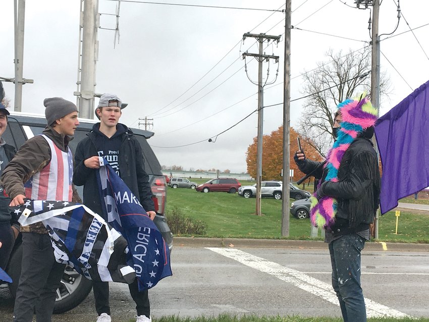 Lansing resident Geoph Espen (right) films interaction with a small group of Trump supporters who openly mocked them and used words such as &ldquo;fag&rdquo; and &ldquo;gay&rdquo; as insults toward the counter-protesters.