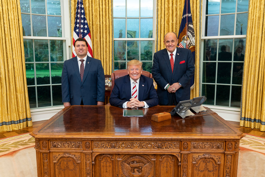 Xavier DeGroat (left), an autistic Lansing Community College student who interned at the White House last semester, in the Oval Office with President Donald J. Trump and his personal lawyer, Rudolf Giuliani, who helped him secure the four-month gig.