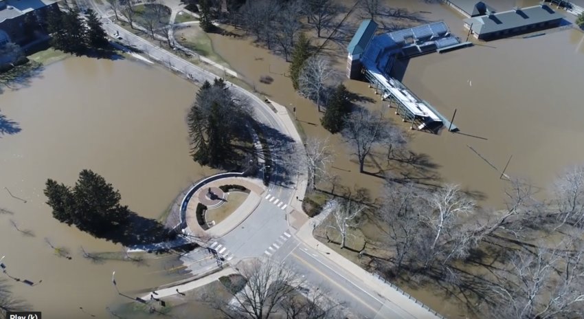 The Red Cedar surged up to Sparty (lower left) and MSU&rsquo;s McLane Baseball Stadium (right) in a February 2018 flood. The past decade has been the wettest on record in mid-Michigan, the most conspicuous local effect of climate change.