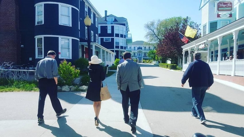 Central Michigan University Professor Steve Coon (left) walks alongside Jen Eyer and TJ Bucholz, of Vanguard Public Affairs, while at the Detroit Regional Chamber&rsquo;s Mackinac Policy Conference.