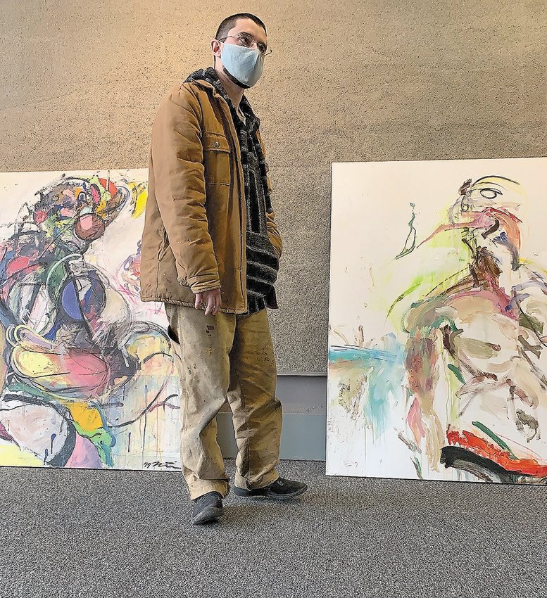 Matias Brimmer with two of his paintings.