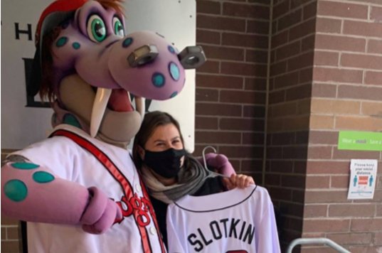Congresswoman Elissa Slotkin with her husband, Dave Slotkin, dressed up as the Lansing Lugnut's mascot, Big Lug.