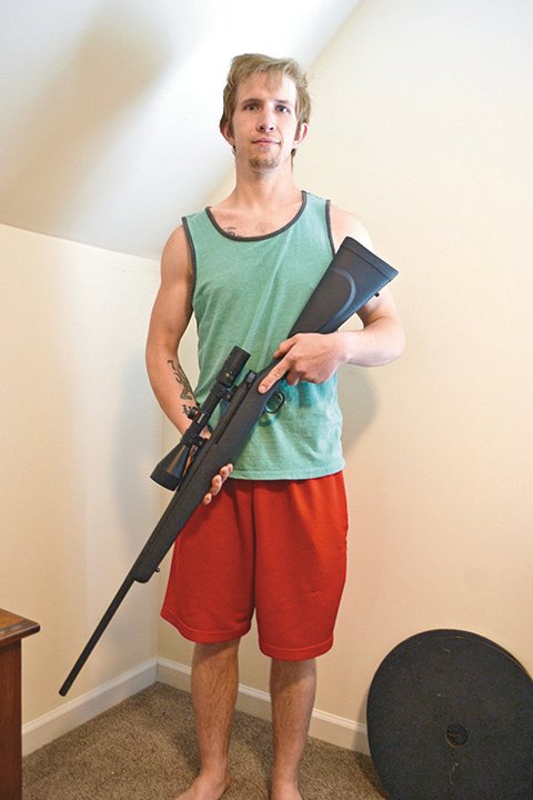 Dane Kowalk with his Mossberg hunting rifle.