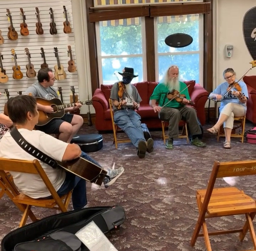 People gather for a jam session at Elderly Instruments during Arts Night Out on Aug. 13.