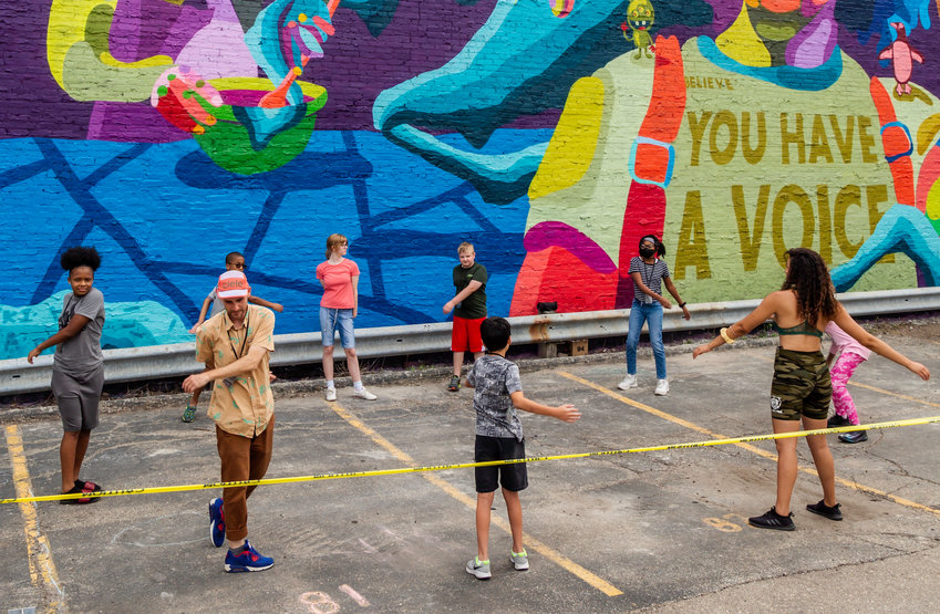 Dustin and students during a team-building exercise at the Grand Avenue mural.