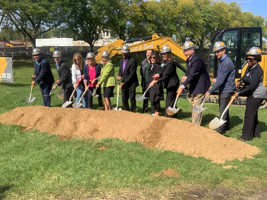 Partners in the development of a new universally accessible playground at Adado Riverfront Park line up for a groundbreaking ceremony.