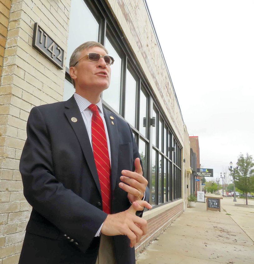 After closing three sales last Thursday in REO Town, departing Ingham County Treasurer and Land Bank Chairman Eric Schertzing took a moment to survey some parcels the Land Bank has helped to revive over the years, including renovated office space at 1142 S. Washington Ave., now home to the McClelland &amp; Anderson law firm.