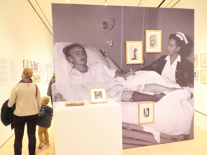A partition at the MSU Broad&rsquo;s &ldquo;Kahlo Without Borders&rdquo; exhibit shows Kahlo resting, cigarette in hand, at Mexico City&rsquo;s ABC Hospital in 1953 after the amputation of her right leg.