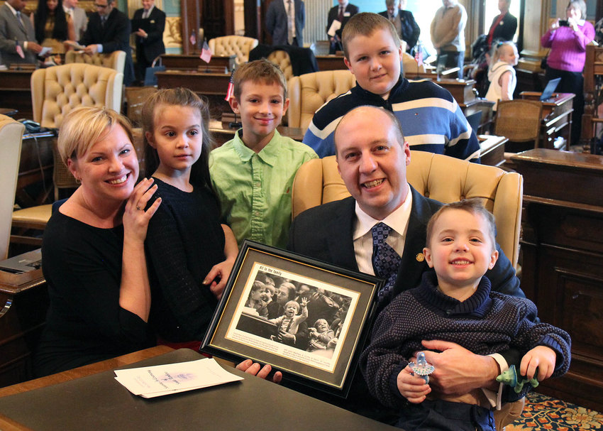 State Sen. Curtis Hertel poses with his family at the State Capitol.