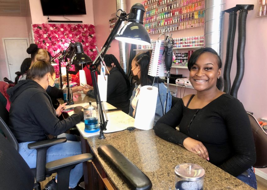 Dymond Brown (right), owner of Onyx Nail Bar, sits at her station, ready for her next nail client.&nbsp;&nbsp;