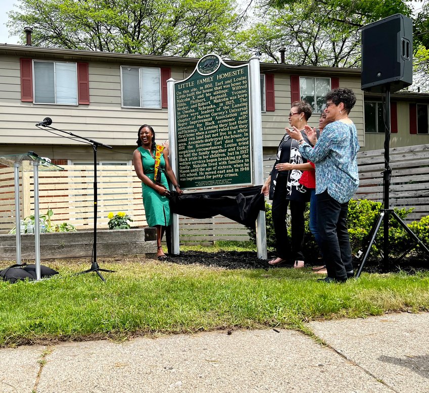 State Rep. Sarah Anthony (left) unveils a new historical marker alongside members of Malcolm X's family.