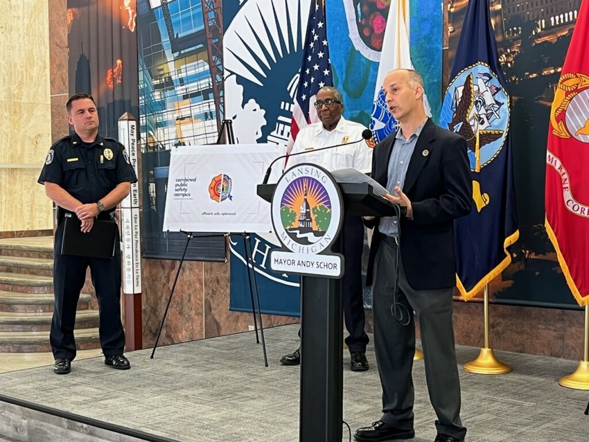 Lansing Mayor Andy Schor explains his proposal for a new public safety and courts building for Lansing at a press conference today at City Hall. Looking on are (left) Police Chief Ellery Sosebee and Fire Chief Brian Sturdivant.