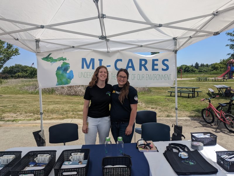 Community activists at the Pittsfield Farmers Market offer information about MI-CARES. Credit: MI-CARES.  &ndash;