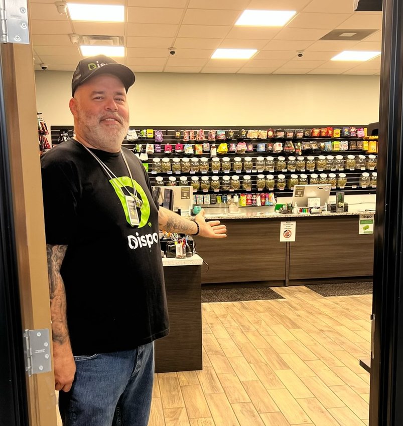 Budtender Juan Moody shows off the goods at Dispo in Lansing.