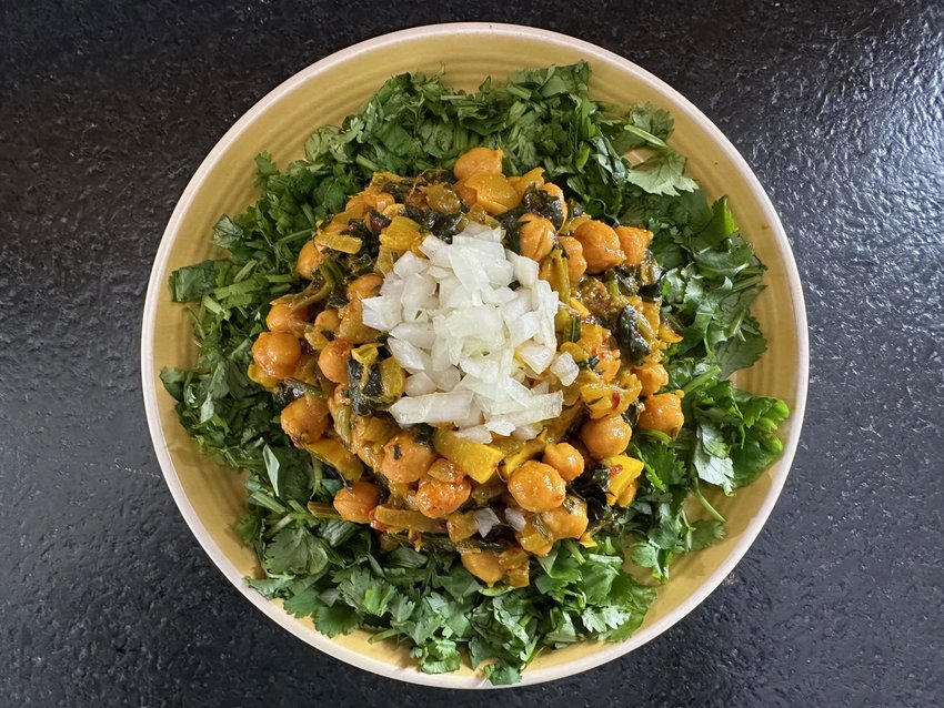 Indian chefs have many tricks for making vegetarian dishes satisfying without resorting to imitation meat. In this Indian-inspired chickpea recipe, the raspy flavor of the turmeric, the piercing bite of the lemon, the herbal aroma of the cilantro and the earthy flavor of the spinach combine for an entr&eacute;e that&rsquo;s both simple and complex.