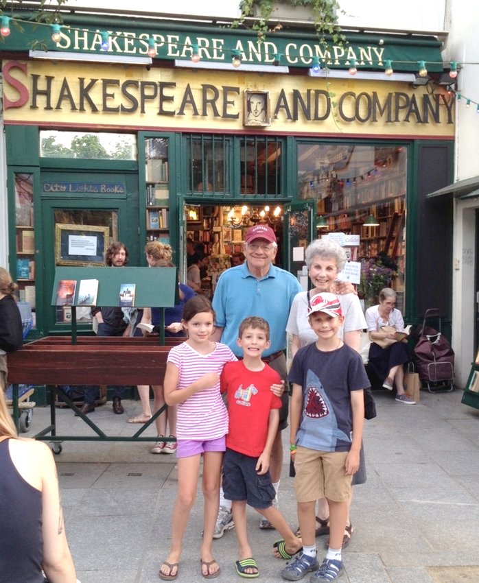 Jack Davis; his wife, Sue; and their grandchildren pose in front of Shakespeare and Co. on a family trip to Paris. Jack Davis&rsquo; rare book collection sold for $718,750 at auction, and his wife has been donating the proceeds to Lansing-area charities.