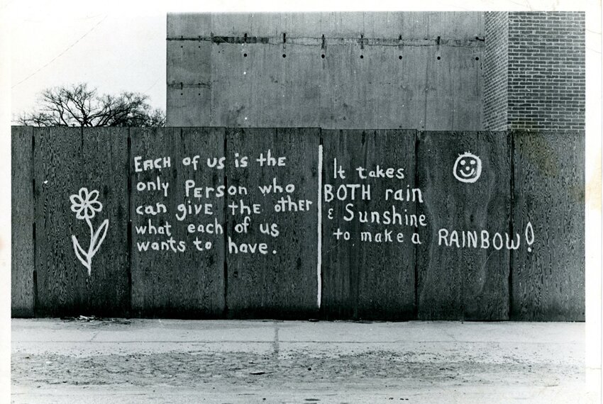 Graffiti on plywood construction barriers near Lansing Community College&rsquo;s downtown campus, photographed in 1971. The mural was adapted into a wedding invitation for Bill and Mary Castanier in 1972.