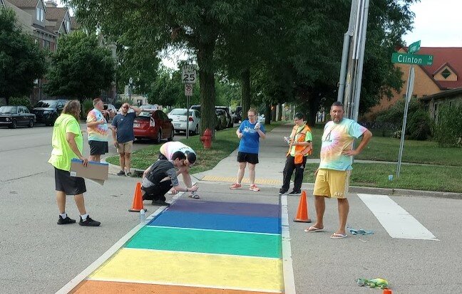 Ben Dowd (right) working with Lansing Pride volunteers in 2022 for the organization&rsquo;s first festival. Lansing Pride returns to Old Town this Saturday (June 17).