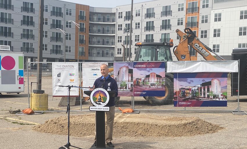 Lansing Mayor Andy Schor opens the groundbreaking ceremony this morning for the city's downtown performing arts center at the corner of Washington Avenue and Lenawee Street. In the background are the new City View Apartments.