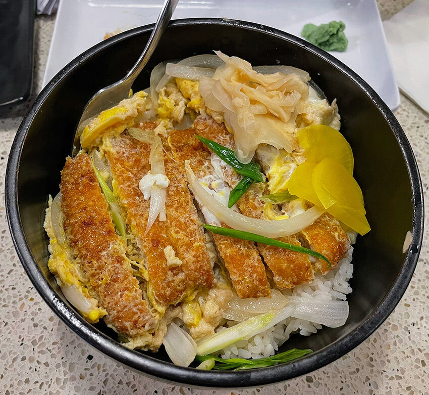 Donburi is a general term that refers to any Japanese rice-bowl dish, no matter the toppings. Mi Sushi &amp; Noodles&rsquo; Chicken Katsu Donburi Rice includes green and white onion, scrambled eggs and perfectly golden-brown breaded chicken.