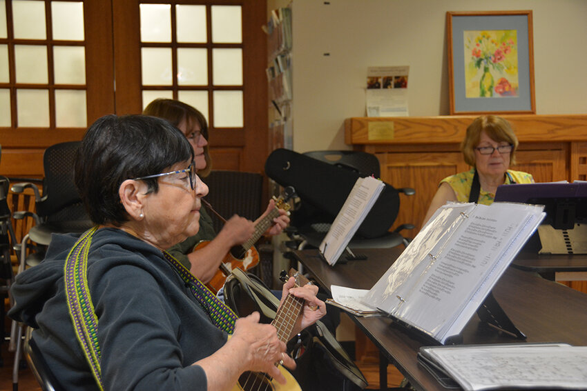 Prime Time Seniors Program participants learn to play ukulele.
