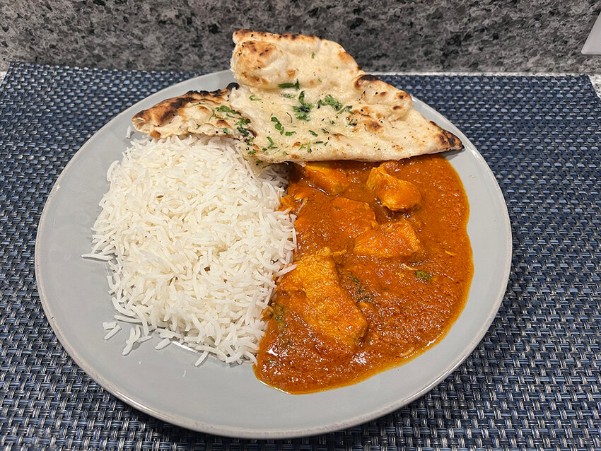 Basmati rice and garlic naan are the perfect accompaniments to tone down the spice level of Sindhu’s chicken vindaloo.