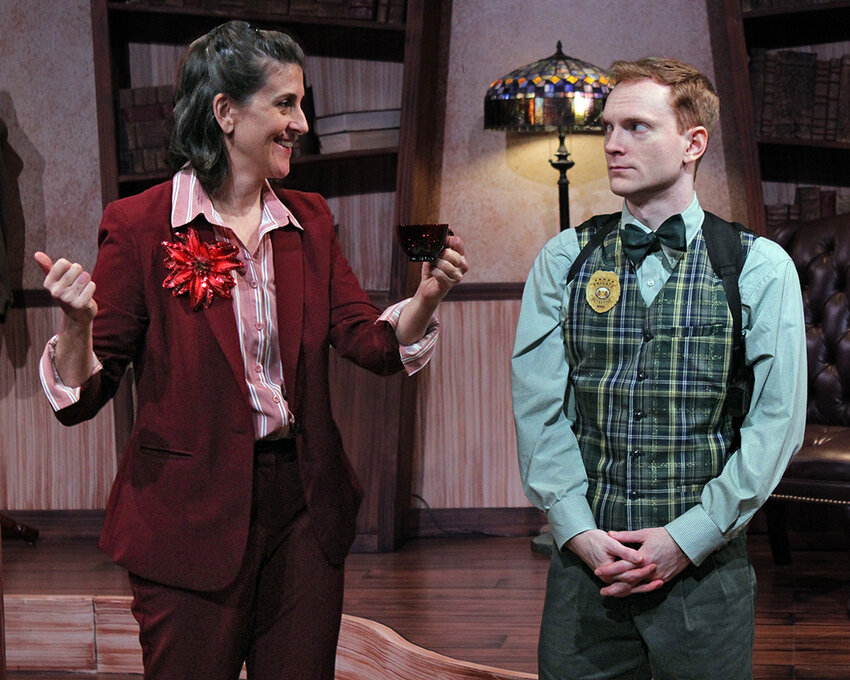 Andrea Wollenberg (left) as suspect Dahlia Whitney and Mark Schenfisch as police officer Marcus Moscowicz in Williamston Theatre&rsquo;s production of &ldquo;Murder for Two: Holiday Edition.&rdquo;