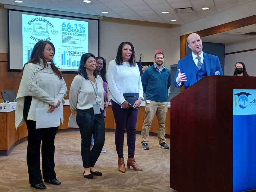Lansing Schools Superintendent Ben Shuldiner (at lectern) highlights the work done by the three woman to his right: (from left) Anna DiPonio, the district&rsquo;s director of assessment and evaluation; Heather Guerra, director of instruction for literacy and social studies; and Yvonne Thomas, director of instruction for math and science.
