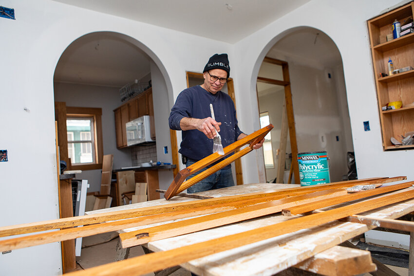 Dave Muylle, who has been restoring homes for more than 40 years, working on one of the properties comprising Cottage Lane on Lansing&rsquo;s east side. Muylle has built six new properties, restored seven, and has one more to build to complete the project. The last step will be to convert them to condominiums.
