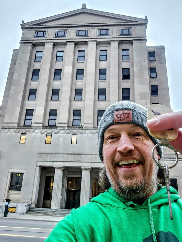 Lansing Foodies co-president James Brains clutches the &quot;keys&quot; to Lansing's former Masonic Temple in a photo posted to the group's Facebook page.