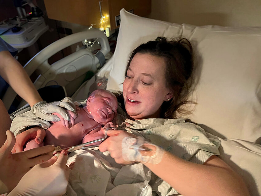 Kendra Ouillette cuts the umbilical cord, welcoming her second daughter, Bennett, into the world in the early morning hours of March 12 at E.W. Sparrow Hospital.