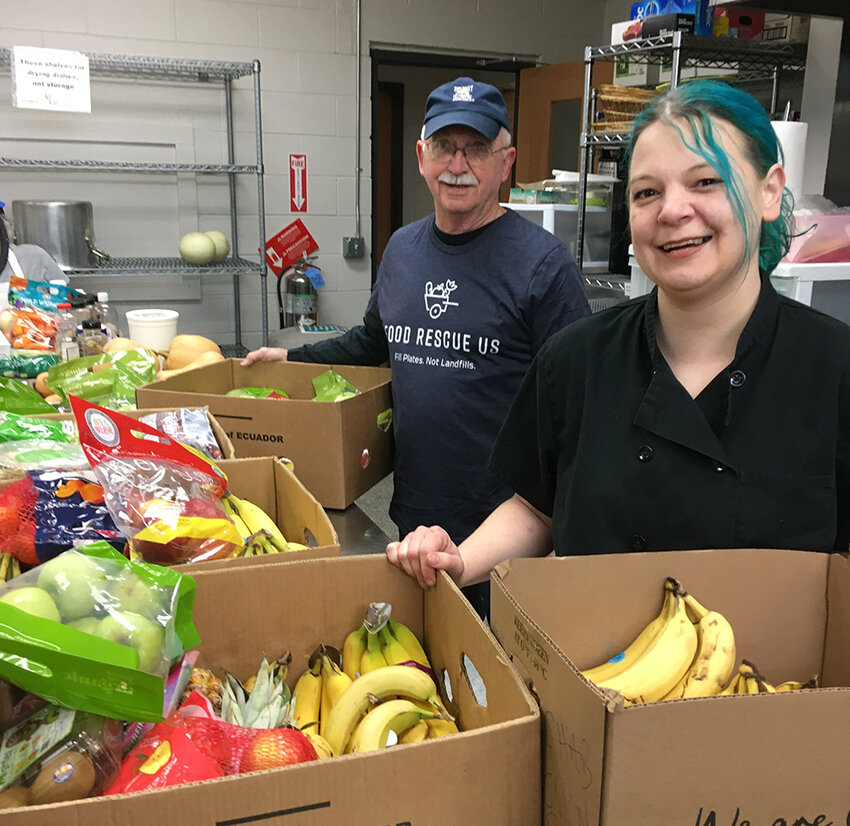 Volunteers at Southside Community Kitchen in Lansing, including (from right) Corey Kitley-Hassenger and Dave Batten, are among organizations in greater Lansing who accept food and ensure it gets to those in need.