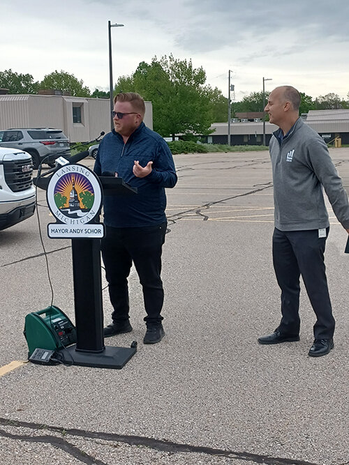 Ryan Kost (left), the First Ward Councilmember who opposed moving City Hall to the Masonic Temple, joins Mayor Andy Schor at a press conference announcing the plan to build the new city hall at the corner of Grand Avenue and Lenawee Street.