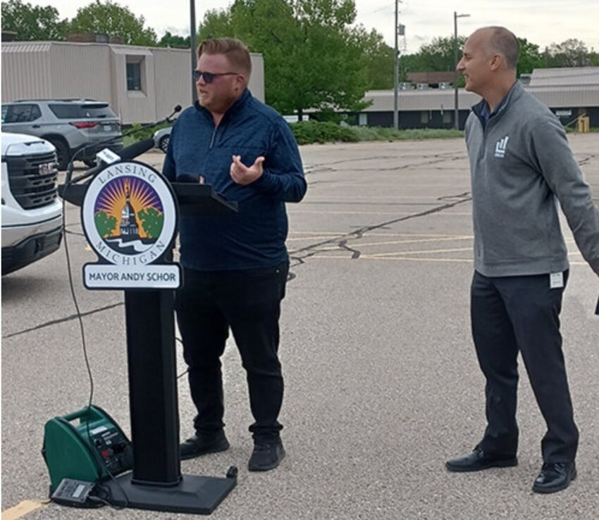 Ryan Kost (left), the First Ward Councilmember who opposed moving City Hall to the Masonic Temple, joins Mayor Andy Schor at a press conference announcing the plan to build the new city hall at the corner of Grand Avenue and Lenawee Street.