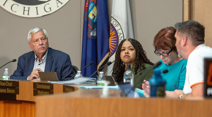 Lansing Charter Revision Commission Chair Brian Jeffries (left) listens as Commissioner Ben Dowd (right) makes a point at last night's meeting at City Pulse. Between them are Commissioners Lori Adams Simon (left) and Jody Washington.