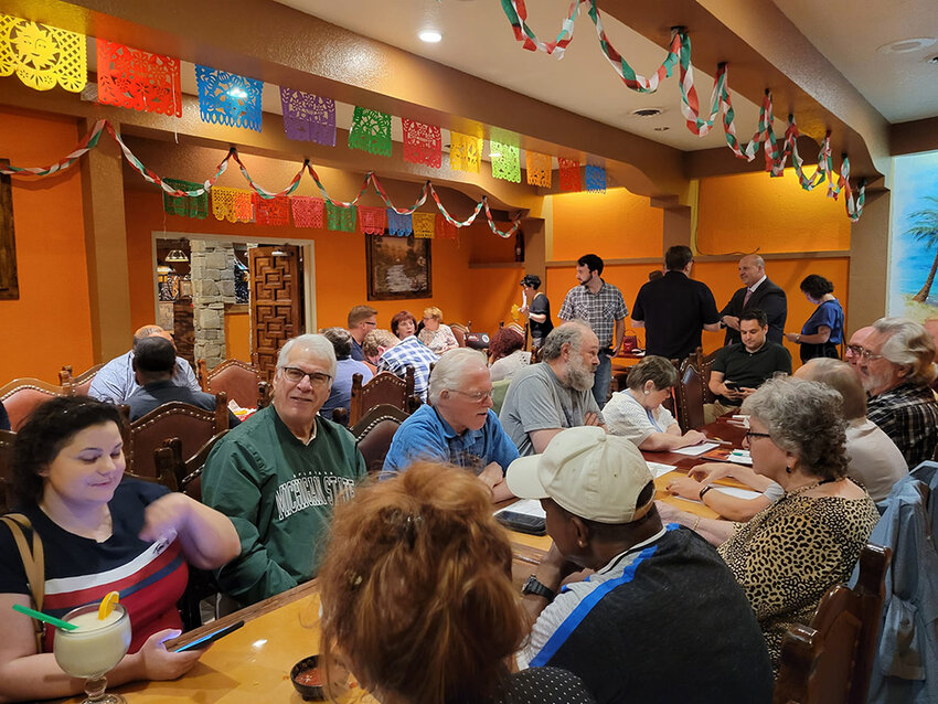 Ingham County Democrats gather for August 2023 meeting at Fiesta Charra restaurant on Lake Lansing Road. Congressional candidate Curtis Hertel Jr., in the black suit in the back, may be among down-ticket candidates who benefit from the shakeup at the top of the ticket.