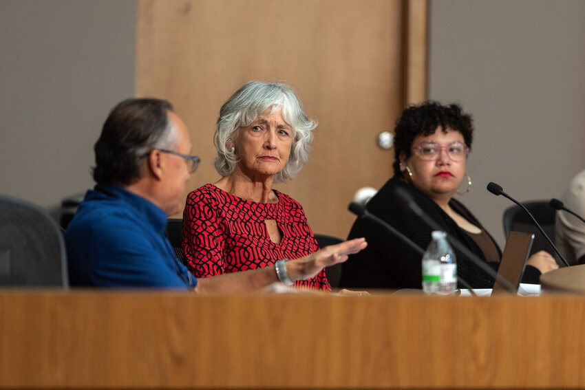 (From left) Lansing Charter Commission member Guillermo Lopez discusses a pair of legal firms to represent the panel with members Joan Bauer and Jazmin Anderson. The commission voted 8-0 for the Grand Rapids-based firm Cummings, McClorey, Davis and Acho.